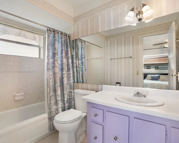 a bathroom with a sink toilet a mirror and shower