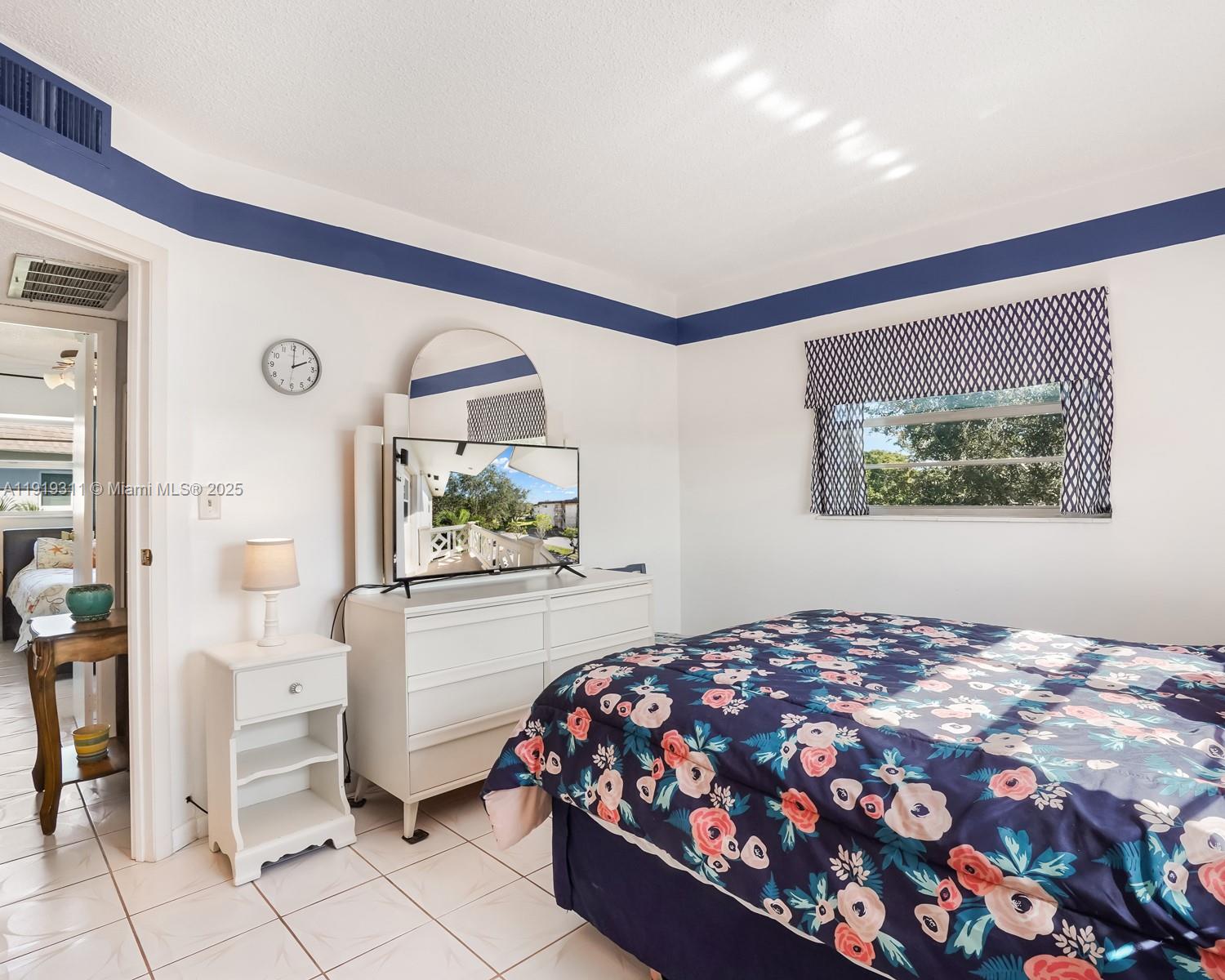 4705 Northwest 35th Street, Unit 616 Lauderdale Lakes, FL 33319 - Photo 13 of 33 a bedroom with a large bed and a window