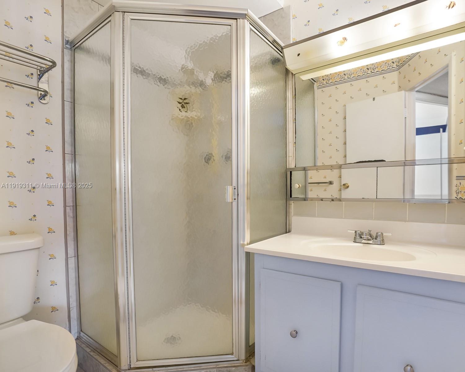 4705 Northwest 35th Street, Unit 616 Lauderdale Lakes, FL 33319 - Photo 15 of 33 a bathroom with a shower sink vanity and mirror
