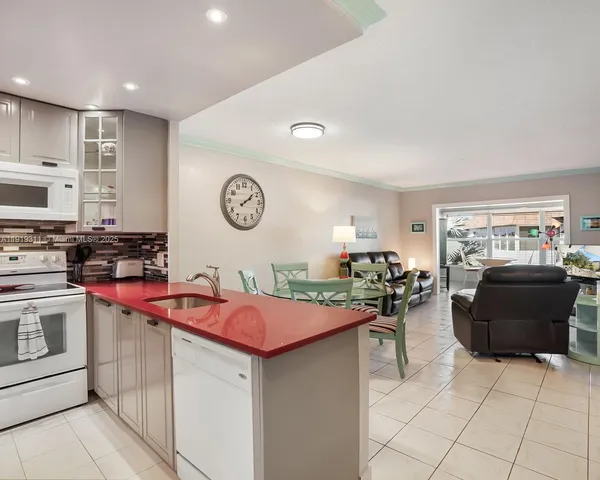 a kitchen with stainless steel appliances granite countertop a sink and cabinets