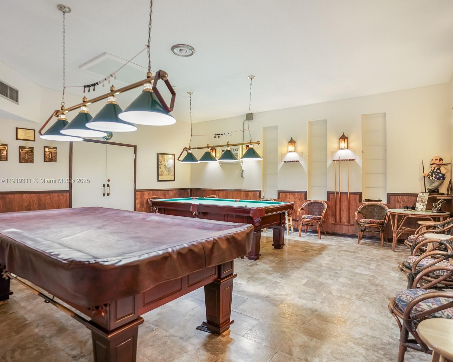 4705 Northwest 35th Street, Unit 616 Lauderdale Lakes, FL 33319 - Photo 26 of 33 a spacious bedroom with a bed a chandelier and dresser