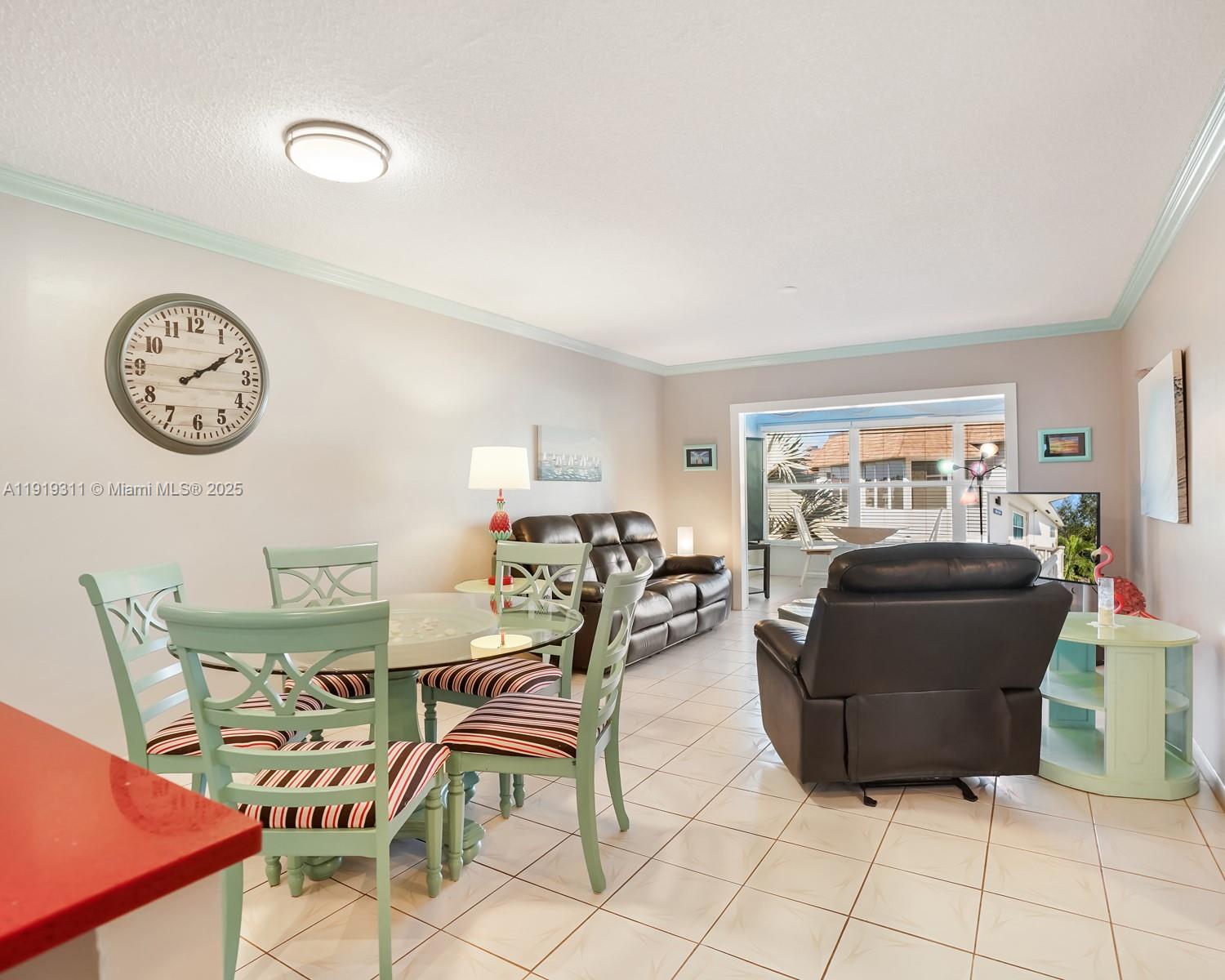 4705 Northwest 35th Street, Unit 616 Lauderdale Lakes, FL 33319 - Photo 3 of 33 a living room with furniture and a clock