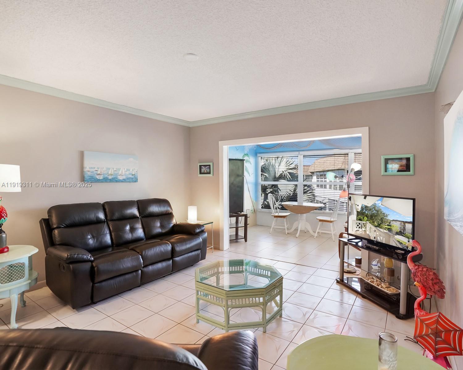 4705 Northwest 35th Street, Unit 616 Lauderdale Lakes, FL 33319 - Photo 5 of 33 a living room with furniture and a large window