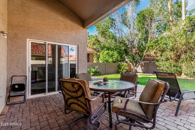 a table and chairs in front of a house