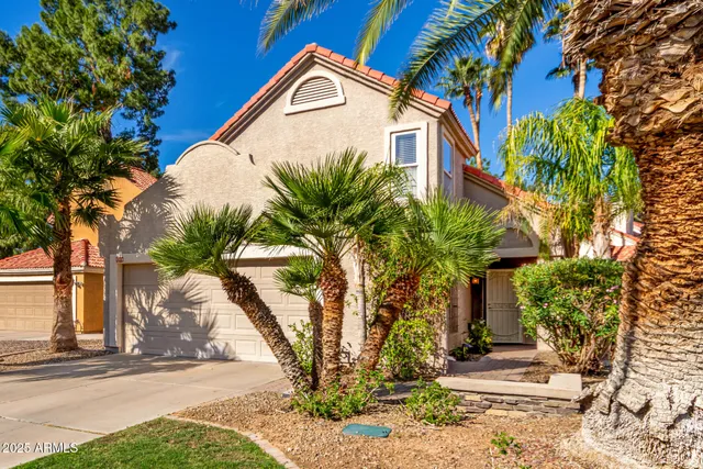 a view of a house with a tree in the background