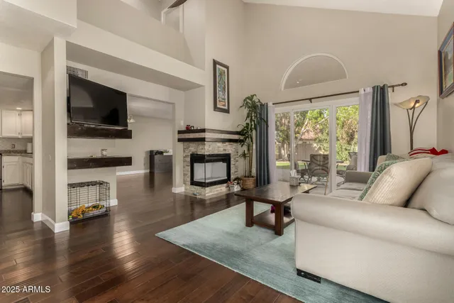 a living room with fireplace furniture and a flat screen tv