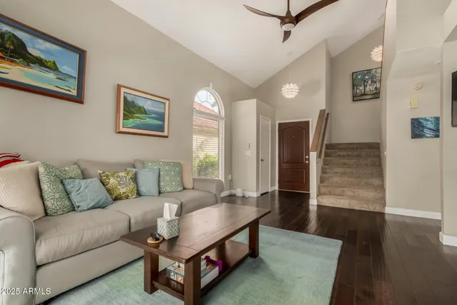 a living room with furniture and a wooden floor