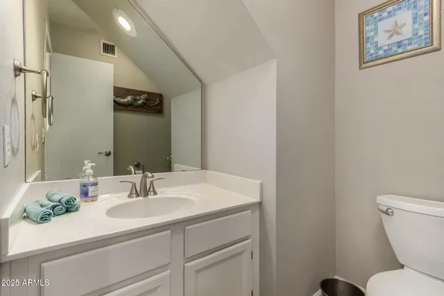 a bathroom with a sink toilet and a mirror