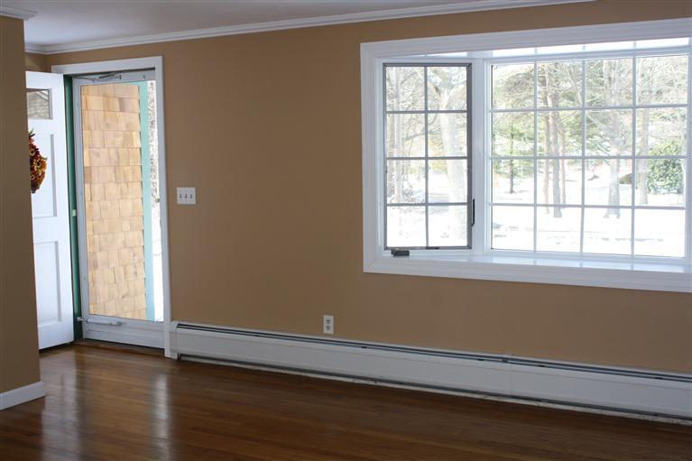 127 Suomi Road Hyannis, MA 02601 - Photo 5 of 15 a view of an empty room with wooden floor and a window
