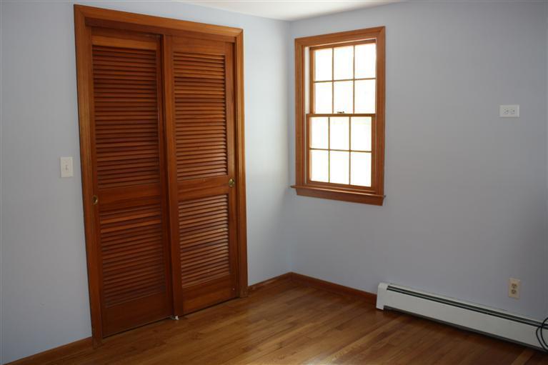 127 Suomi Road Hyannis, MA 02601 - Photo 10 of 15 a view of an empty room with wooden floor and a window