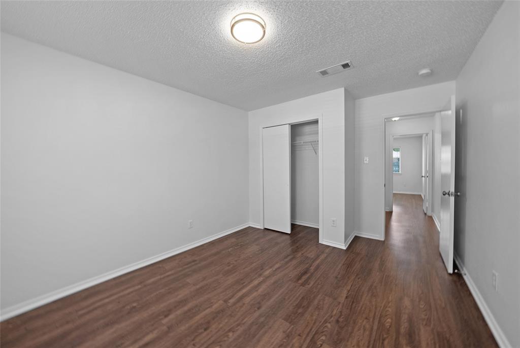 2910 Chisholm Trail Corinth, TX 76210 - Photo 21 of 30 a view of a room with wooden floor and brick walls