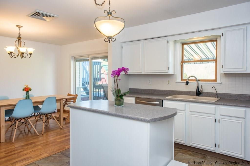 46 Patura Road Modena, NY 12548 - Photo 15 of 26 a kitchen with kitchen island granite countertop a sink cabinets and window
