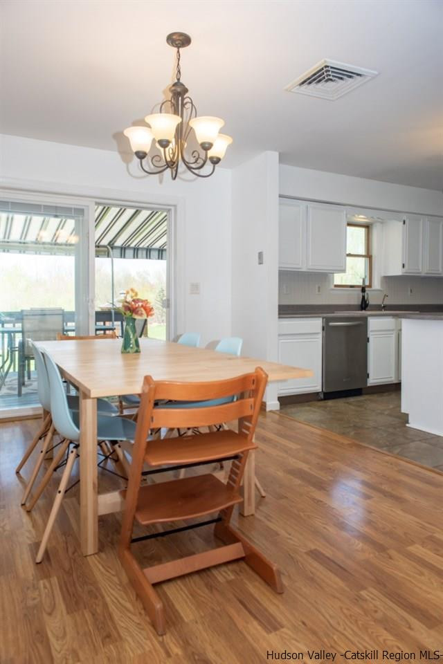 46 Patura Road Modena, NY 12548 - Photo 16 of 26 a room with kitchen island a wooden floor and a view of dining room