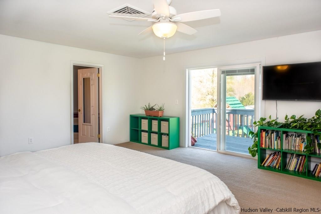 46 Patura Road Modena, NY 12548 - Photo 23 of 26 a bedroom with a large bed and a flat tv screen