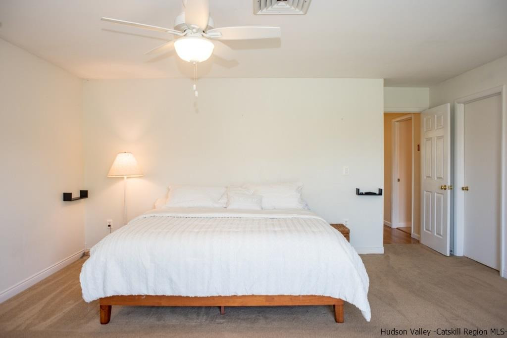 46 Patura Road Modena, NY 12548 - Photo 24 of 26 a bedroom with a bed and a chandelier