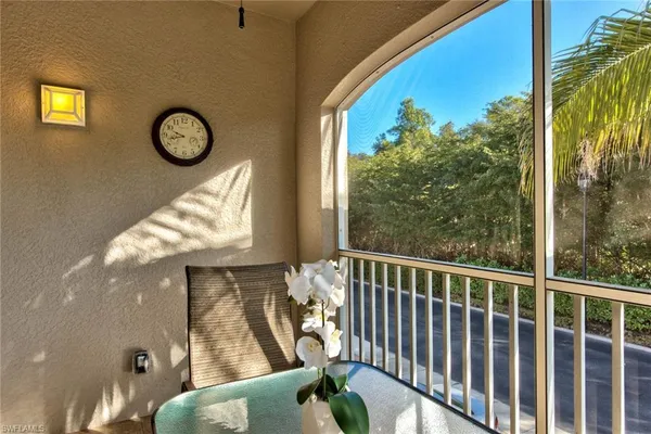 a view of a balcony with chair and wooden floor