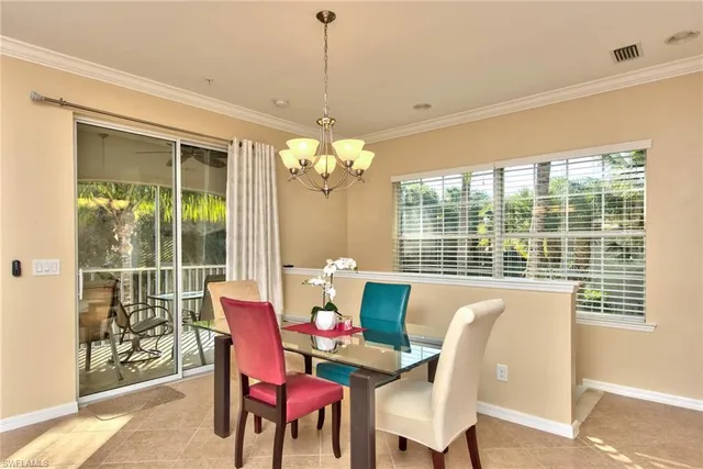 a view of a dining room with furniture large windows and wooden floor