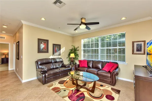 a living room with furniture a rug and a chandelier