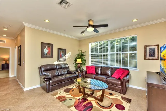 a living room with furniture a rug and a chandelier