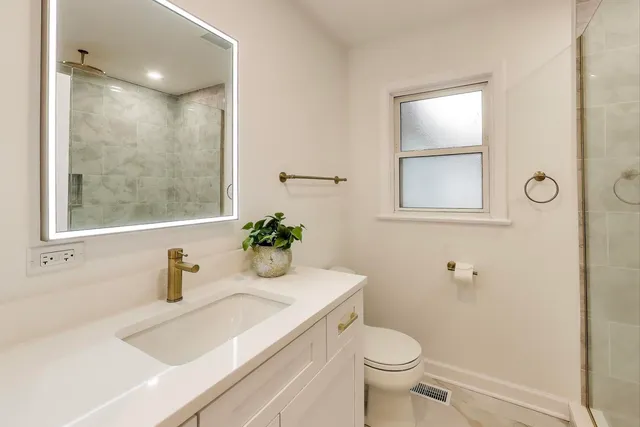 a bathroom with a sink toilet and shower
