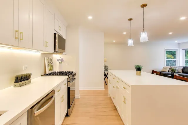 a kitchen with a sink a stove and a refrigerator