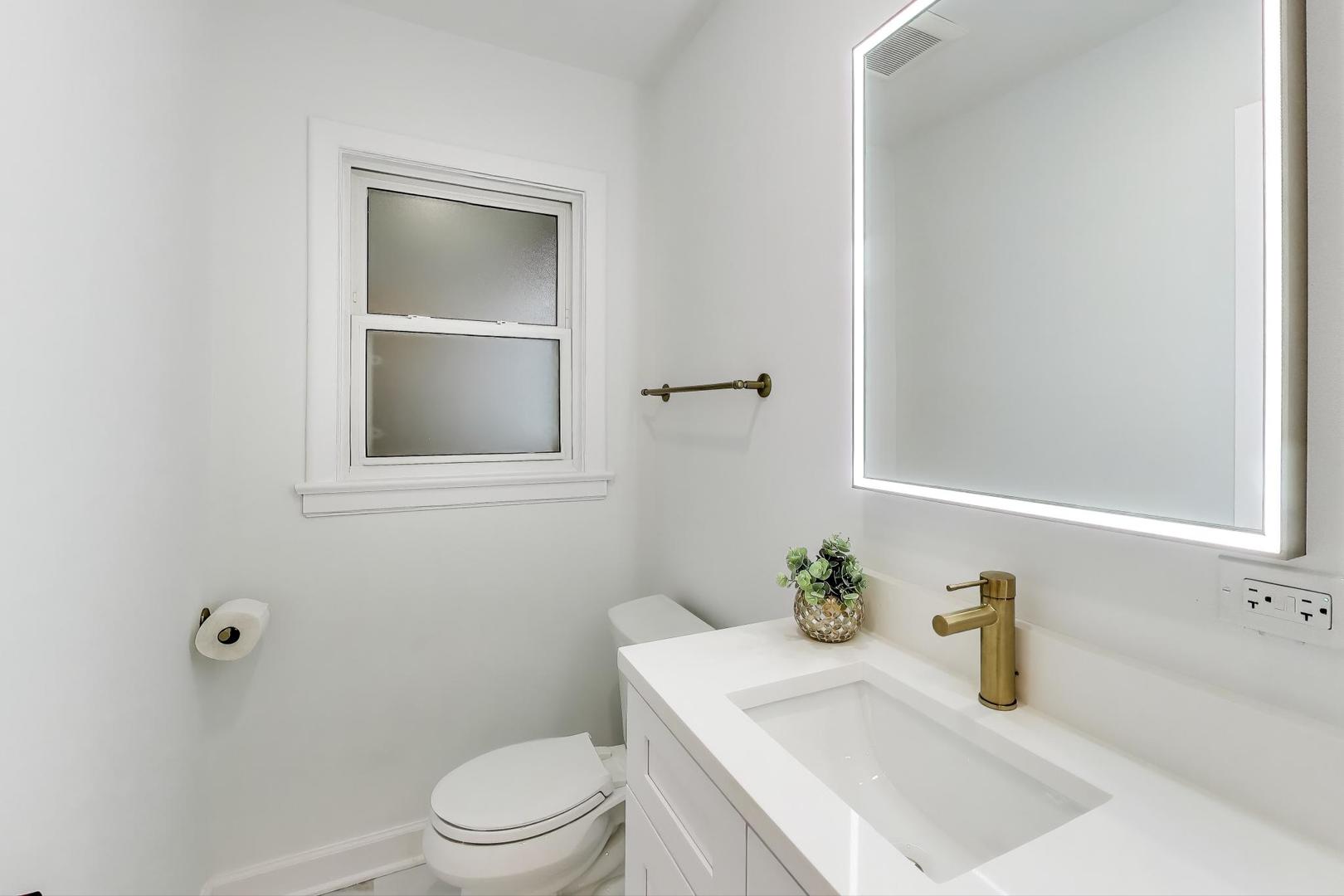 832 North Delphia Avenue Park Ridge, IL 60068 - Photo 9 of 29 a bathroom with a sink a toilet and a mirror