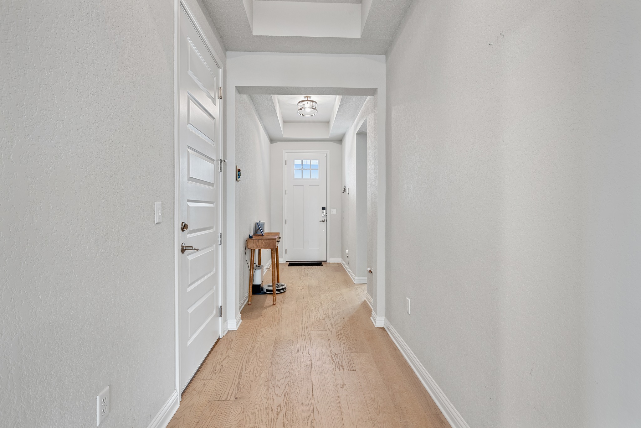 8405 Hubble Walk Austin, TX 78744 - Photo 3 of 36 Doorway with a raised ceiling and wood finished floors
