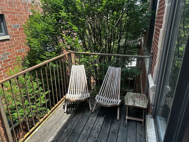 a view of balcony with wooden floor