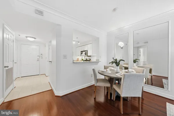 a view of a dining room with furniture and wooden floor