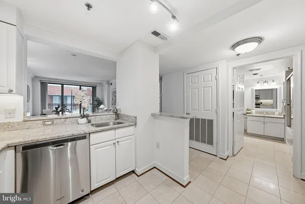 a kitchen with granite countertop a sink and cabinets