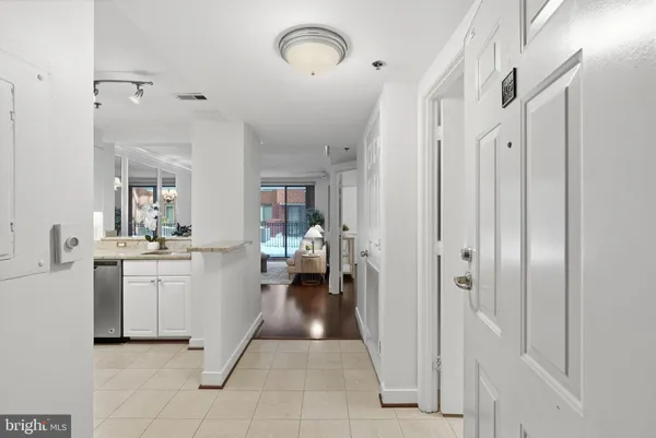 a view of a hallway with bathroom and a sink