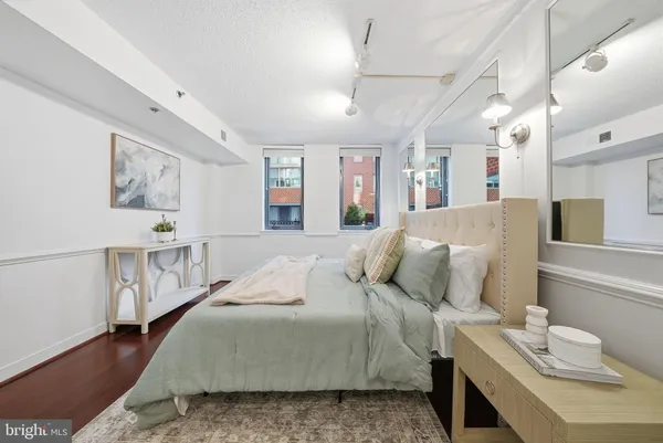 a bedroom with a bed a couch and dresser