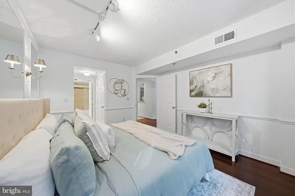 a bedroom with a bed and a chandelier