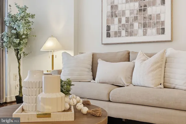 a living room with furniture and a lamp