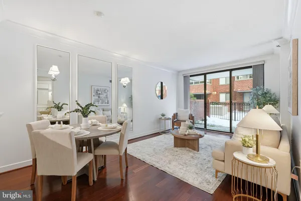 a dining room with furniture a large window and a chandelier