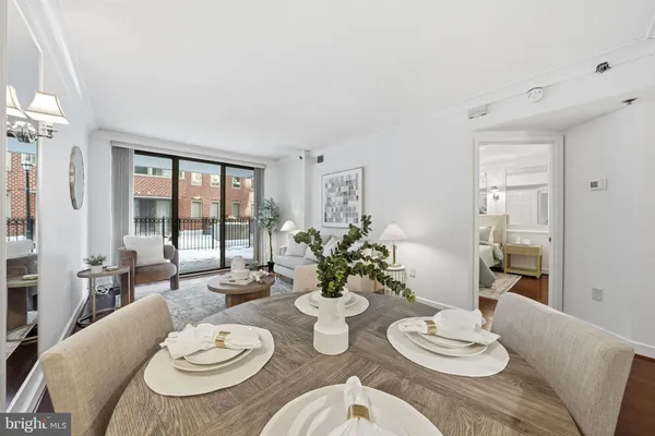 a dining room with furniture a large window and dining table