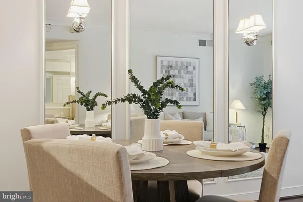 a dining room with furniture and wooden floor