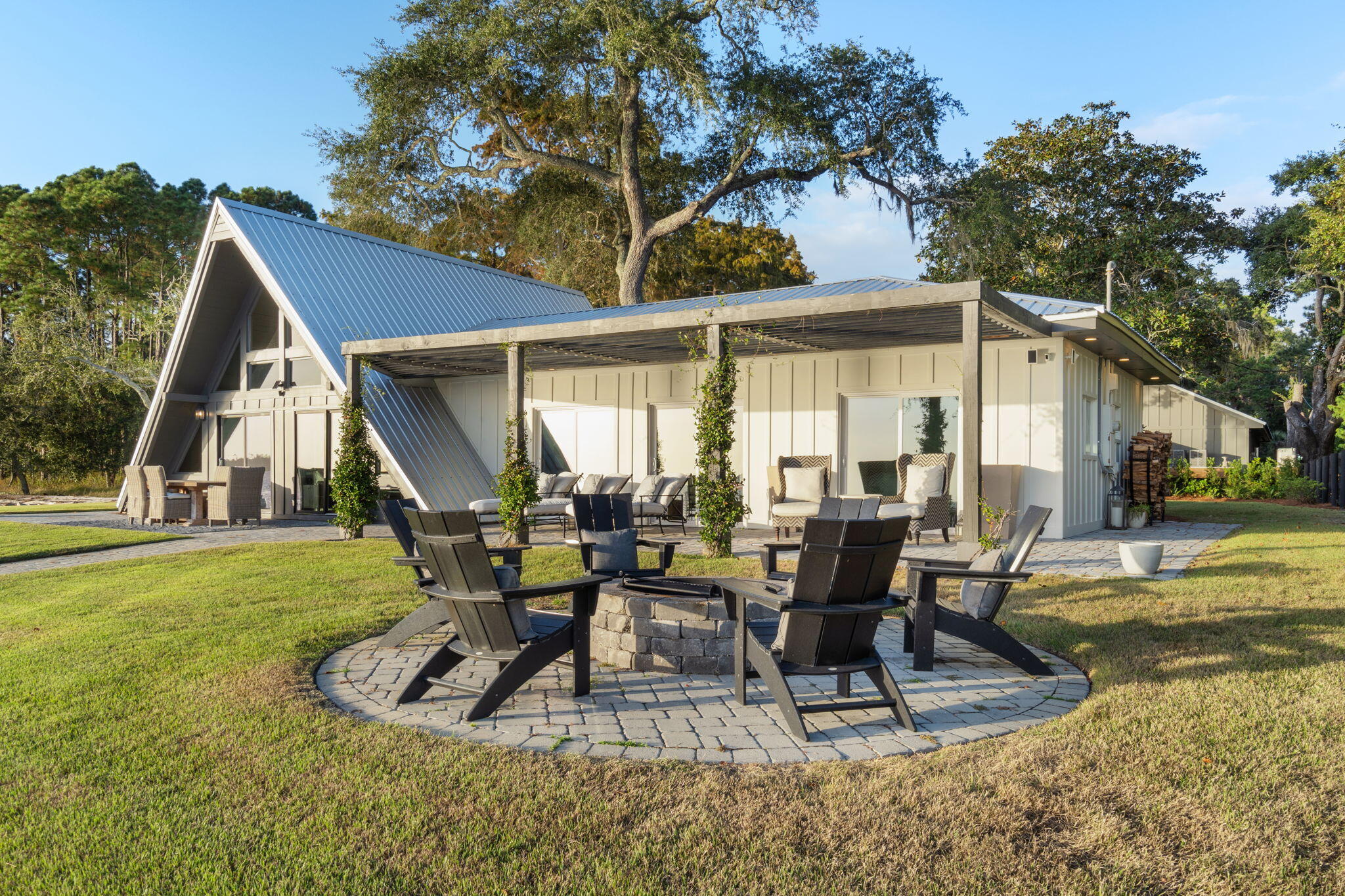 7423-7433 Highway 20 Freeport, FL 32439 - Photo 59 of 69 a view of a patio with table and chairs potted plants and large tree