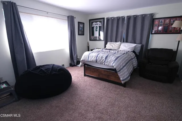 a bedroom with a bed and furniture