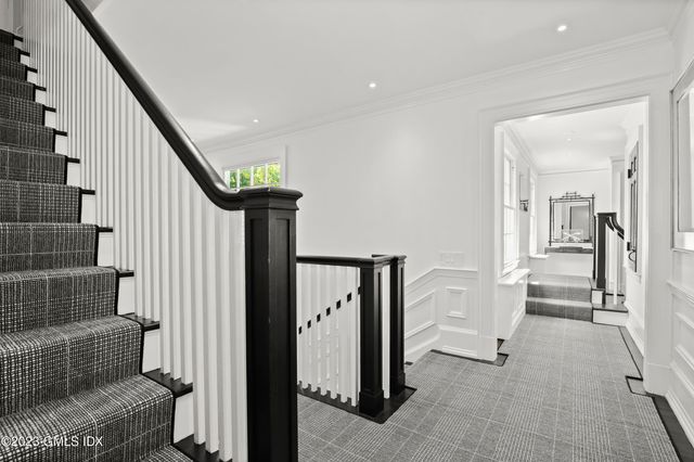 a view of an entryway with wooden floor and a rug