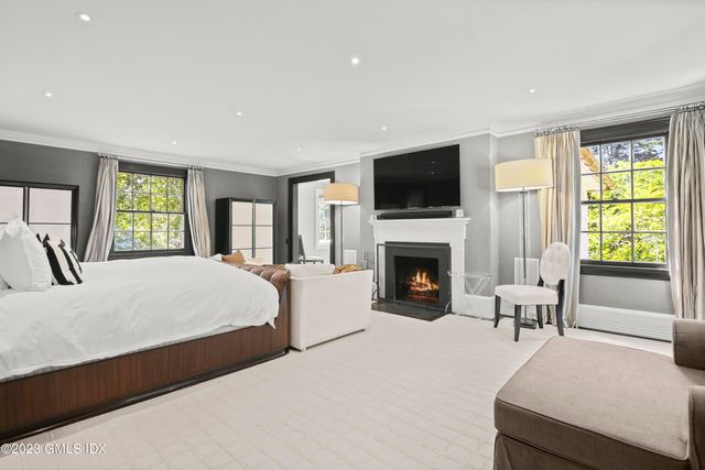 a spacious bedroom with a large bed and a fireplace