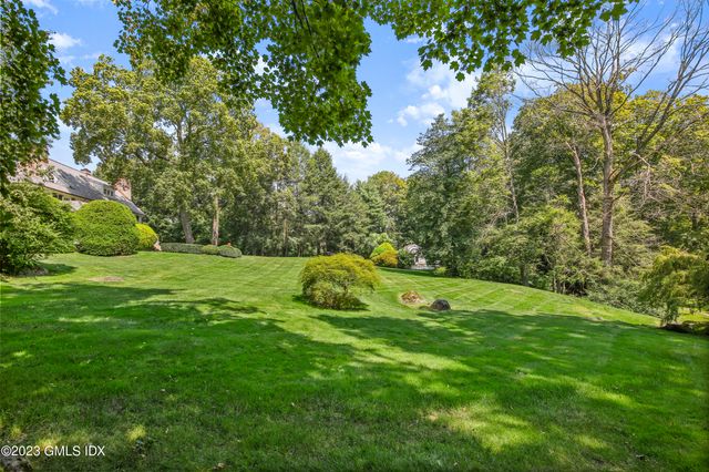 a view of a grassy field with trees