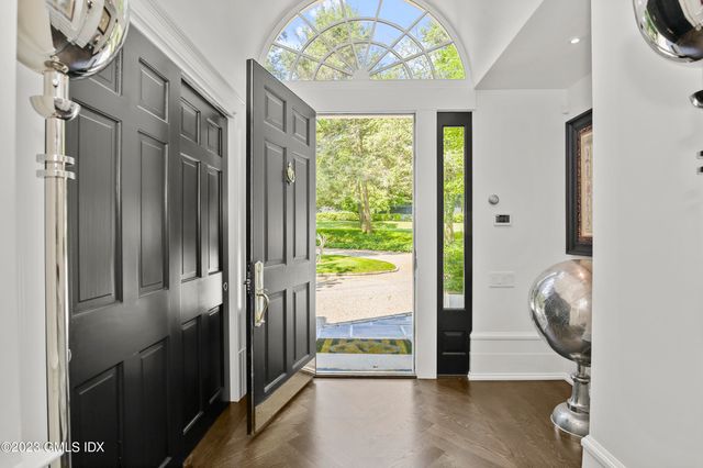 a view of an entryway with wooden floor