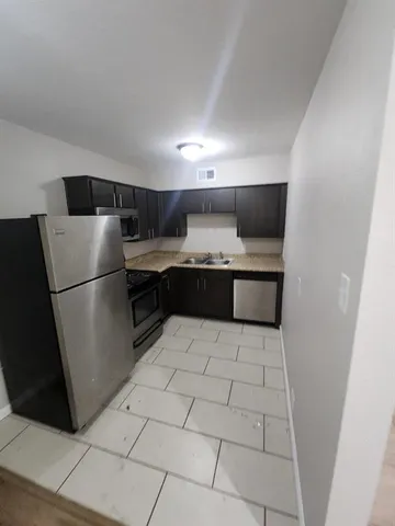 a kitchen with stainless steel appliances a refrigerator and a sink