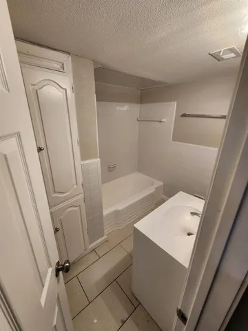 a bathroom with a bathtub and shower
