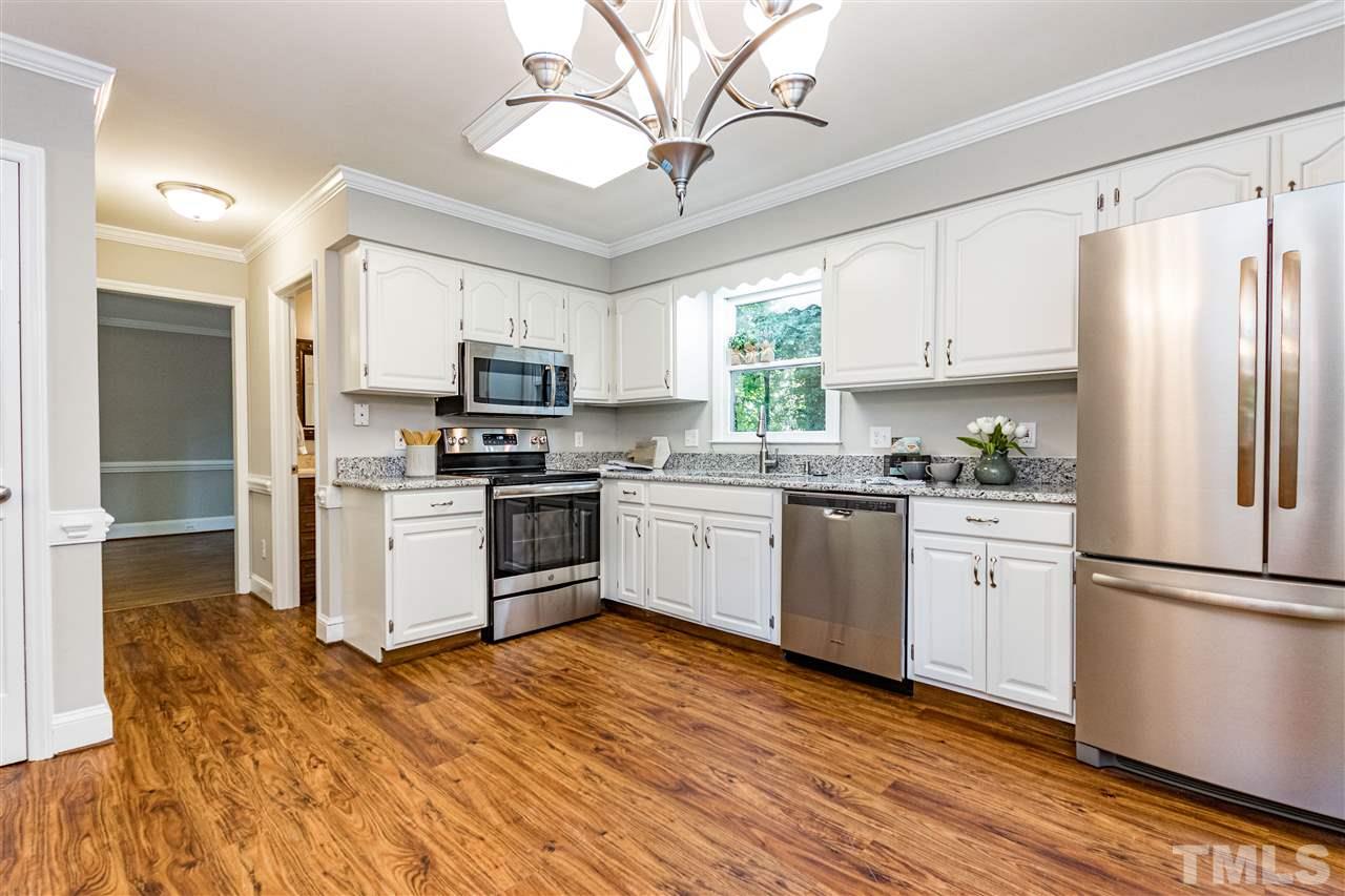 New range, dishwasher, sink, disposal, and refrigerator.
