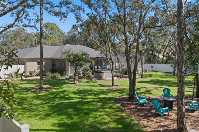 a view of a house with backyard and sitting area