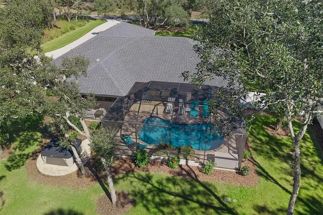 an aerial view of a house with a yard