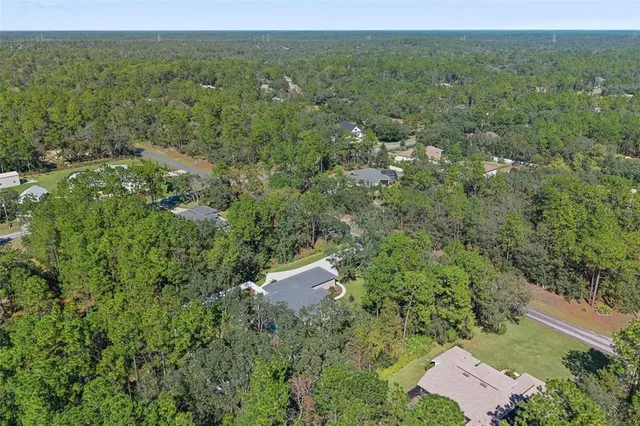 an aerial view of a house with yard and outdoor seating