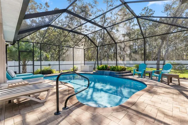 a swimming pool with view of outdoor seating